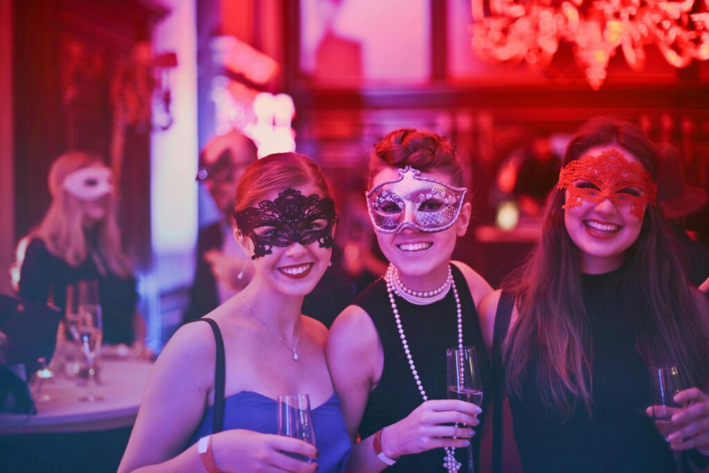 pexels-photo-787961-787961 A vibrant masquerade party with happy guests wearing decorative masks and holding champagne glasses.